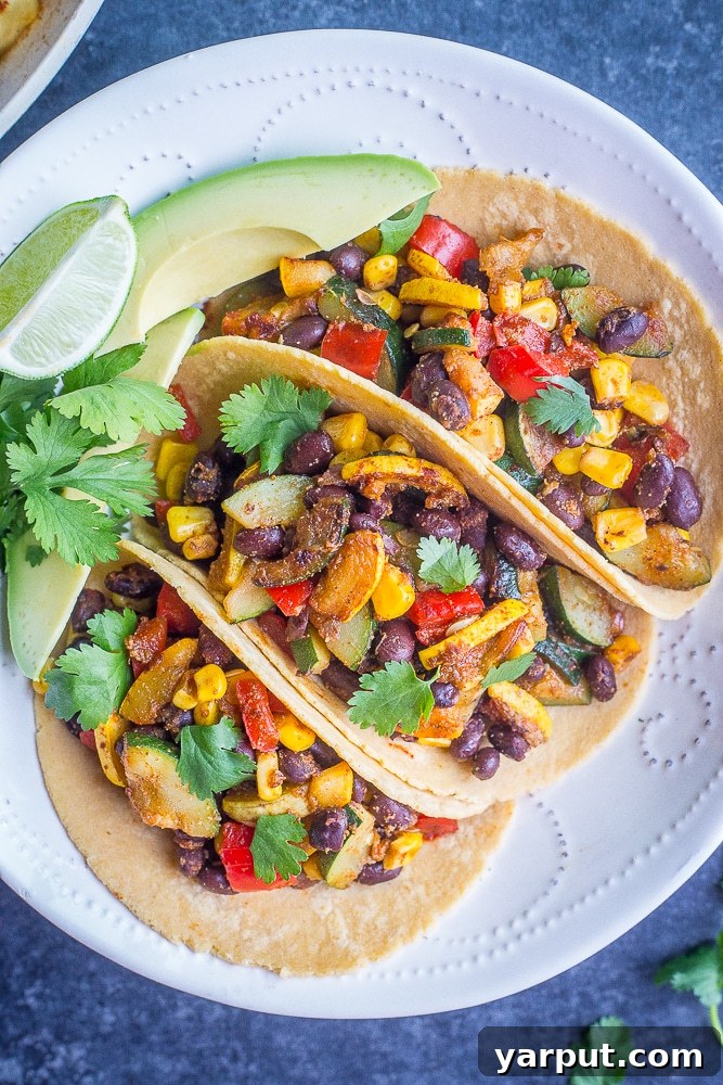 Black Bean Tacos with Summer Vegetables, a fresh and seasonal taco recipe topped with colorful produce.