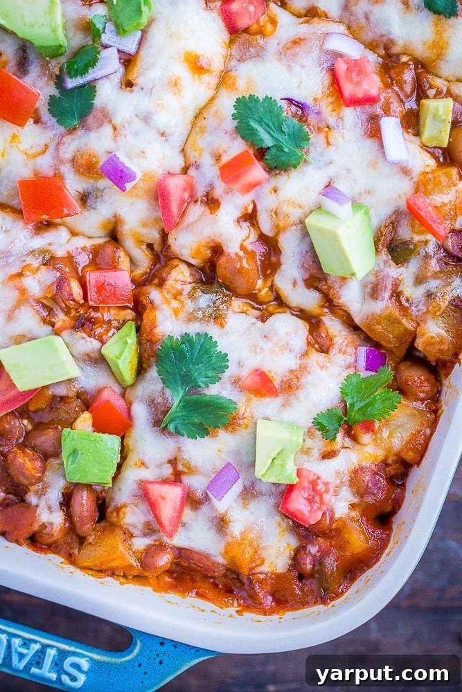 Cheesy Potato Enchilada Casserole, a hearty and comforting vegetarian baked dish, bubbling with cheese.