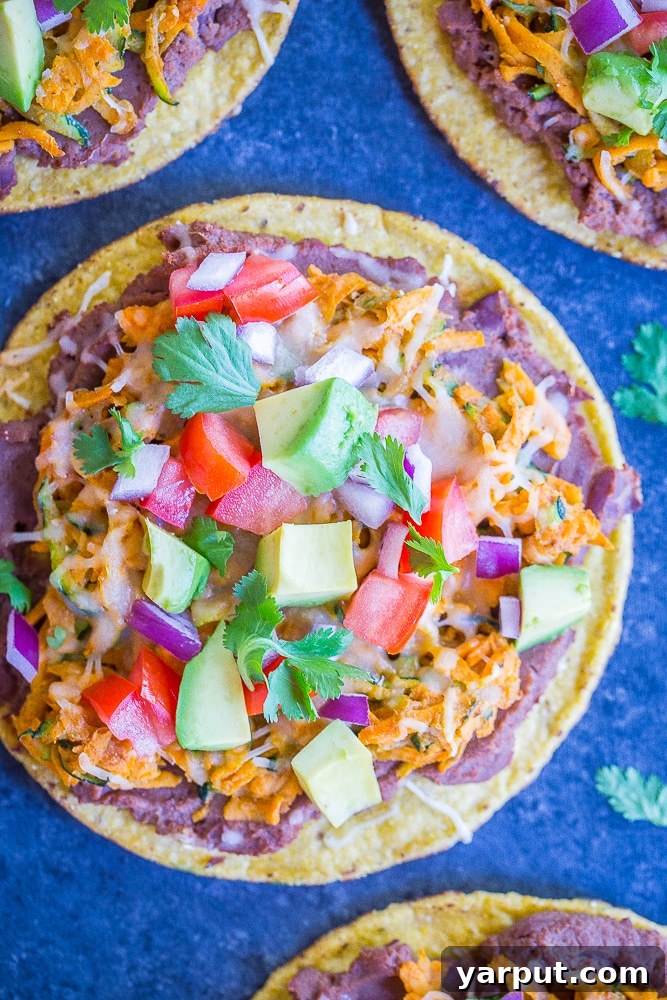 Sweet Potato and Zucchini Tostadas, a light and fresh vegetarian meal, piled high with vibrant toppings.