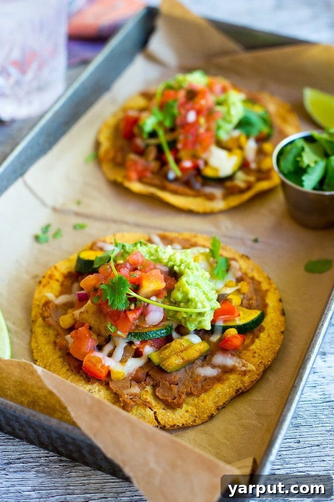 30 Minute Summer Vegetable Tostadas, a quick, fresh, and easy vegetarian dinner, garnished with lime wedges.