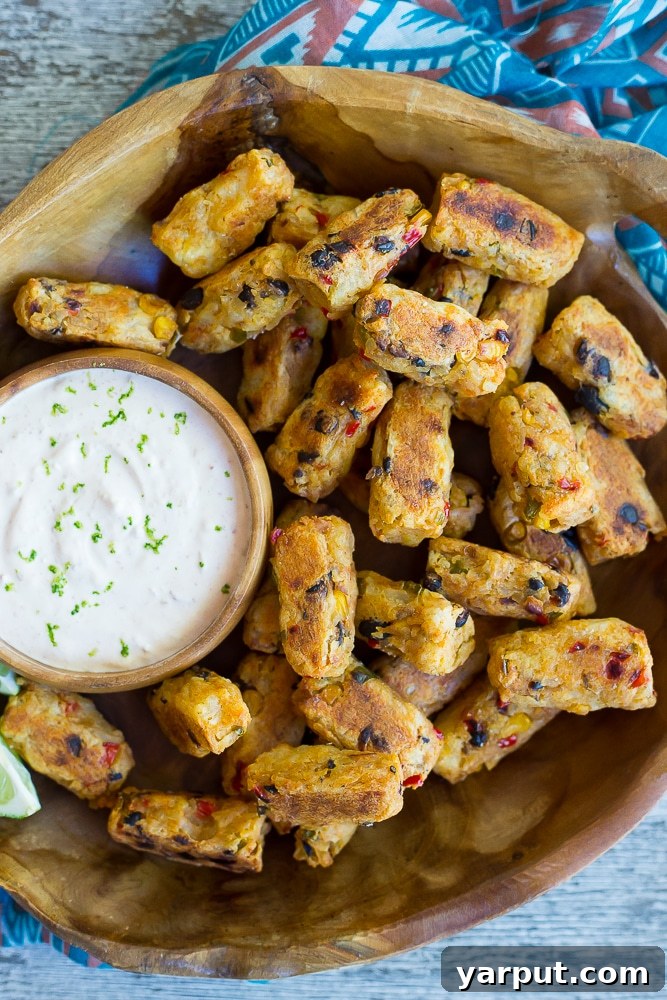 Tex Mex Tater Tots with Creamy Chipotle Lime Dip, a fun and flavorful appetizer or snack, served in a bowl.