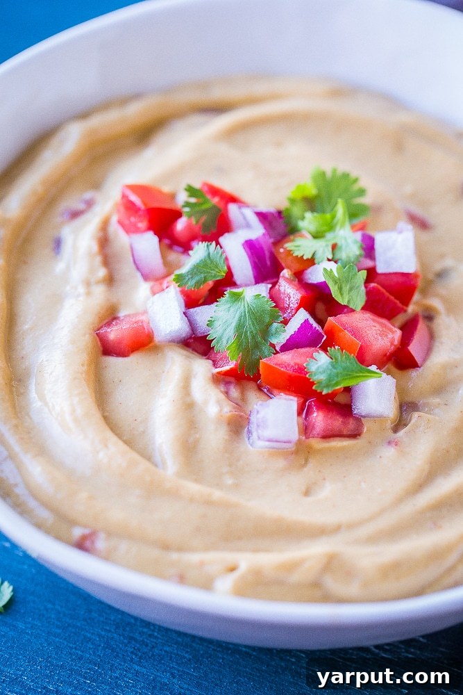 Creamy Cauliflower Queso Dip, a healthy and dairy-free alternative to traditional queso, served warm.