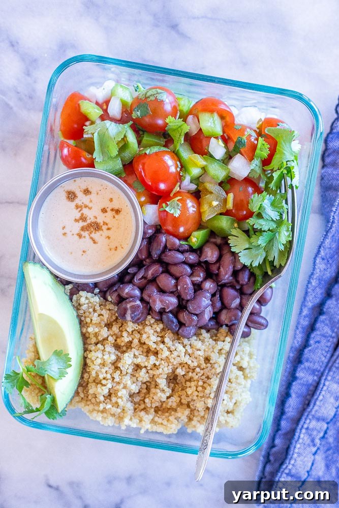 Mexican Quinoa Bowls with Cumin Lime Tahini Dressing, a healthy and vibrant meal prep option, topped with avocado and corn.