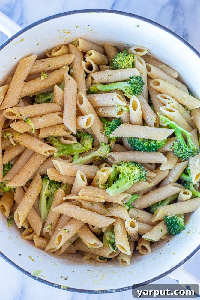 Bright Lemon Broccoli Pasta with Sweet Roasted Tomatoes 3 A large pot filled with freshly cooked lemon broccoli pasta, simmering gently on the stovetop.