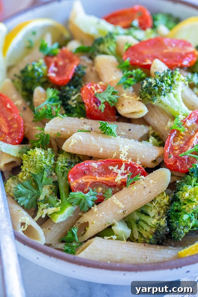 Bright Lemon Broccoli Pasta with Sweet Roasted Tomatoes 6 Overhead close-up of a rustic bowl of lemony broccoli pasta with roasted tomatoes, ready to be enjoyed.
