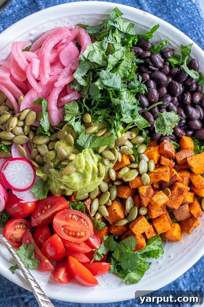 Vibrant Roasted Sweet Potato and Black Bean Kale Power Bowl 5 Close-up shot of a large, inviting bowl of roasted sweet potato and black bean kale salad, highlighting the texture of the ingredients and the rich colors.