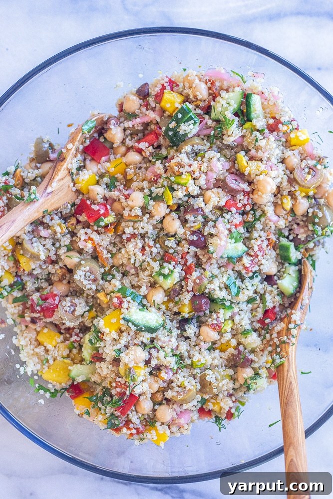 Vibrant Mediterranean Quinoa Bowl 4 A large bowl of easy Mediterranean quinoa salad fully mixed and ready to be served, showing its fresh and vibrant composition.