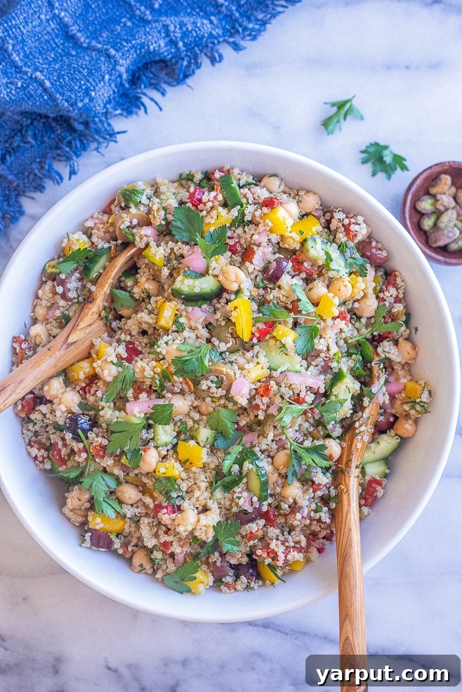 Vibrant Mediterranean Quinoa Bowl 5 The finished Mediterranean quinoa salad in a serving bowl, garnished with fresh herbs, ready for enjoyment.