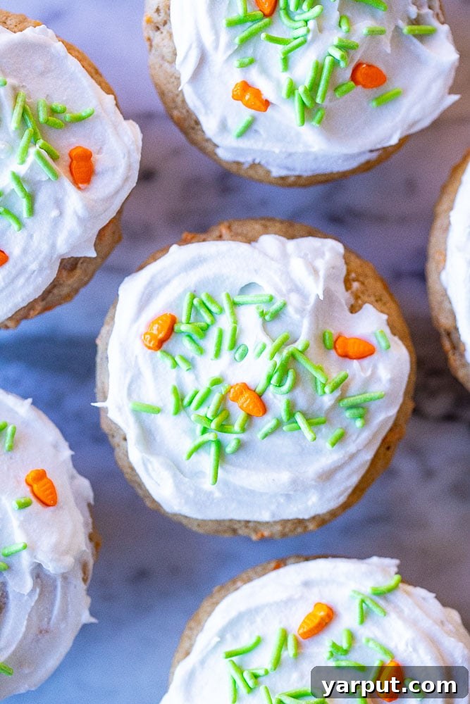 Moist Carrot Cake Muffins 6 Beautifully arranged carrot cake muffins topped with creamy frosting and festive sprinkles, ready to be enjoyed.