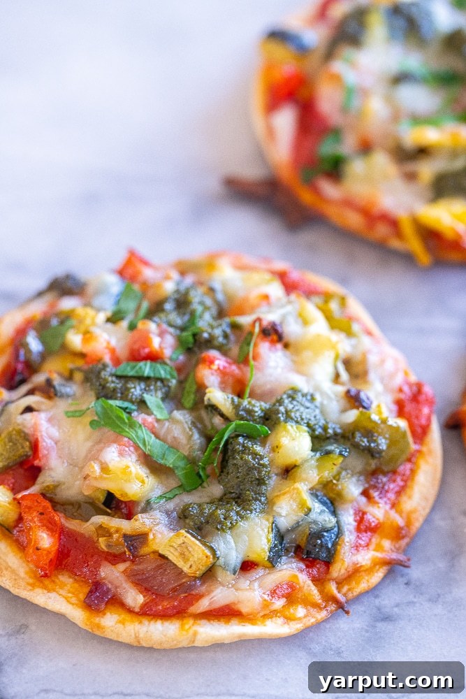 Savory Roasted Vegetable Tortilla Pizzas 5 close up of a tortilla pizza with roasted vegetables and pesto