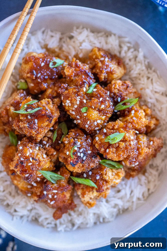 67 Beginner-Friendly Vegan Recipes 30 Golden-brown crispy teriyaki cauliflower florets, coated in a sticky, sweet, and savory glaze, garnished with sesame seeds.