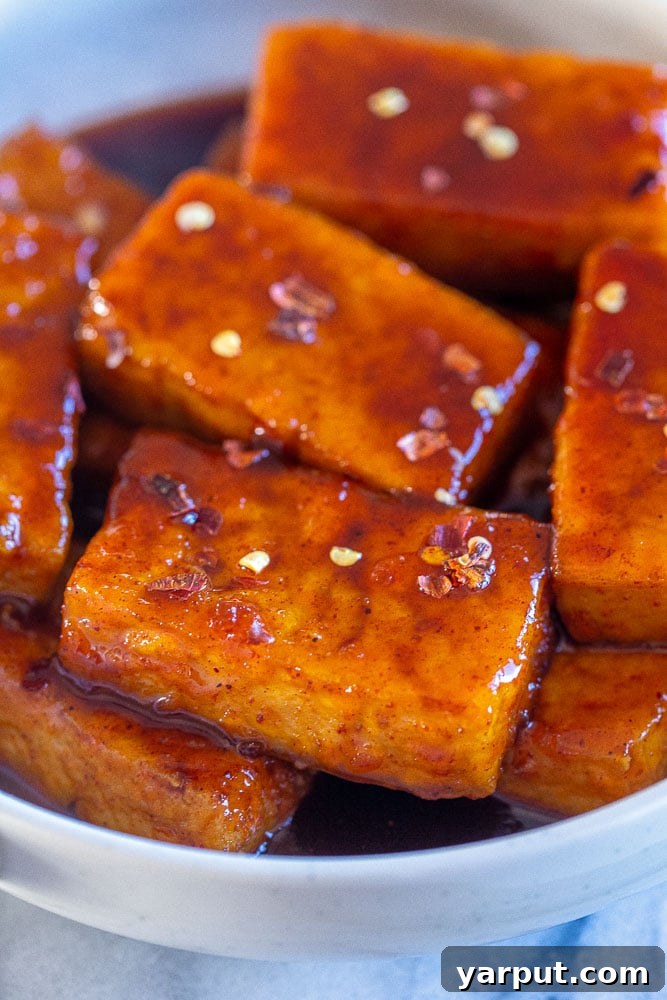 67 Beginner-Friendly Vegan Recipes 10 Tender tofu cubes generously coated in a shimmering maple chili glaze, offering a perfect balance of sweet and spicy flavors.