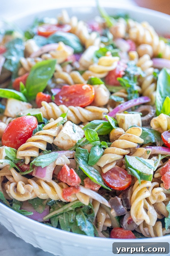 Zesty Arugula Pasta with Tahini Balsamic 5 Close-up photo of the finished creamy Tahini Balsamic Pasta Salad in a serving bowl, showcasing its rich texture, vibrant colors, and fresh ingredients.
