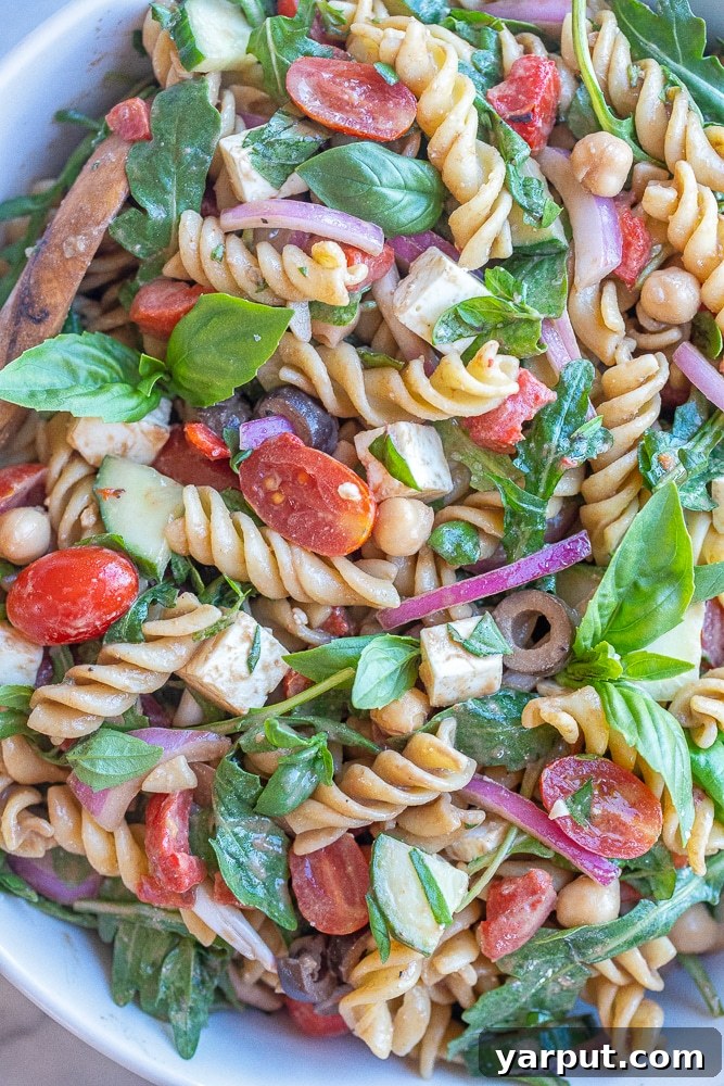 Zesty Arugula Pasta with Tahini Balsamic 6 Close-up of creamy balsamic pasta salad in a bowl, highlighting its texture, fresh ingredients, and readiness for serving.