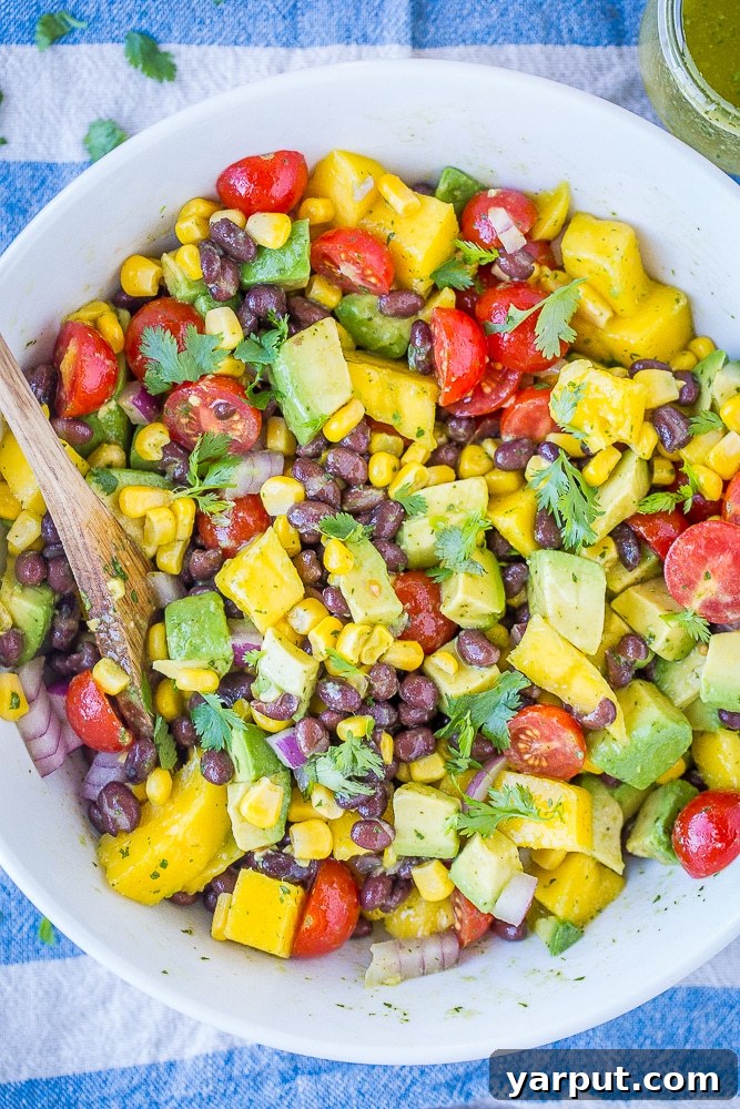 41 Vibrant Summer Salad Ideas 21 Black Bean Salad with Mango and Avocado, a tropical delight.