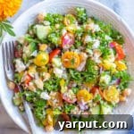A small bowl of Rice Salad with Chickpeas and Kale, perfect for a quick and healthy meal.