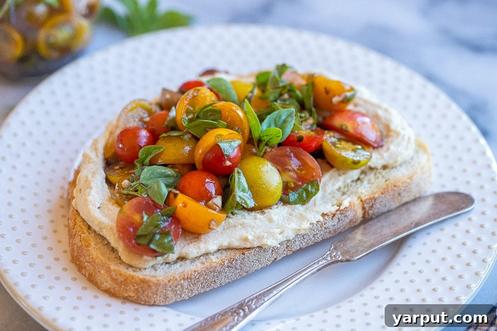 Zesty Bruschetta Hummus Toast 5 A close-up view of the perfectly assembled hummus toast with bruschetta, showcasing fresh ingredients.
