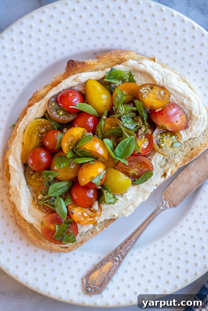 Zesty Bruschetta Hummus Toast 6 Close-up shot of hummus toast with bruschetta, perfectly arranged on a plate.
