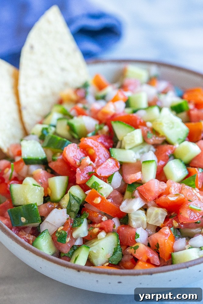 Cool Cucumber Crunch Salsa 5 close up of chunky cucumber salsa recipe in a bowl with chips