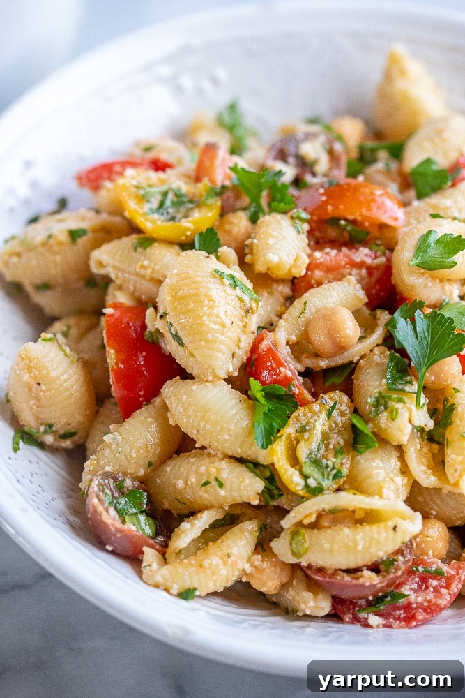 Sun-Kissed Herby Parmesan Tomato Pasta Salad 5 A close-up shot of the Herby Parmesan Tomato Pasta Salad in a mixing bowl, showcasing the fresh, vibrant ingredients and inviting textures.