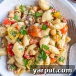 Herby Parmesan Tomato Pasta Salad finished dish, ready to be served from a white bowl.