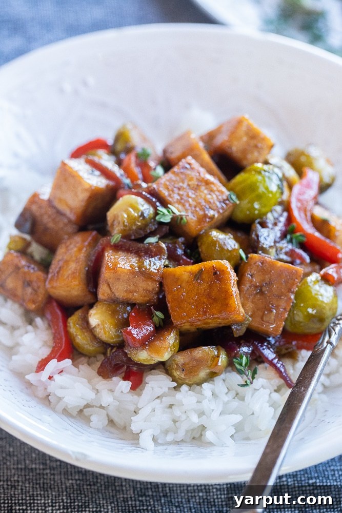 Flavorful Balsamic Tofu and Vegetable Medley 5 A close-up view of the finished balsamic tofu with vegetables, showcasing the rich glaze and vibrant colors in a serving bowl.