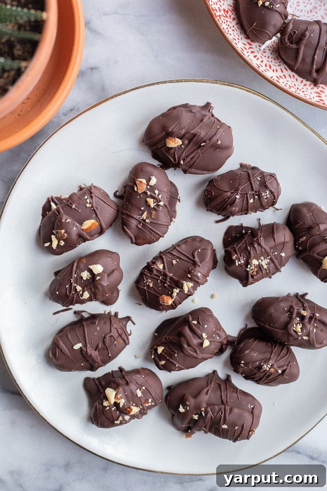 Smoky Almond Butter Chocolate Date Bliss 5 Plate of chocolate covered smoky almond butter stuffed dates