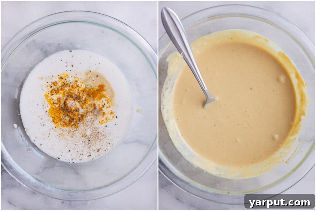 Close-up shot showing the creamy texture of coconut curry tahini dressing being prepared in a bowl.