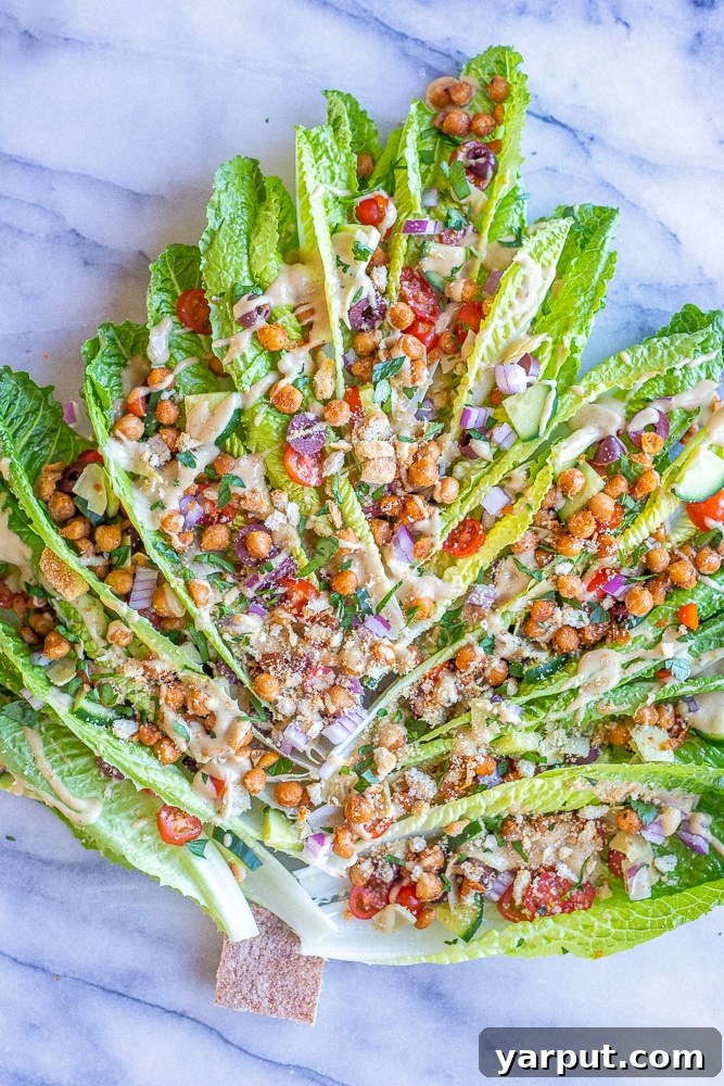 Festive holiday appetizer salad shaped like a Christmas tree with various toppings