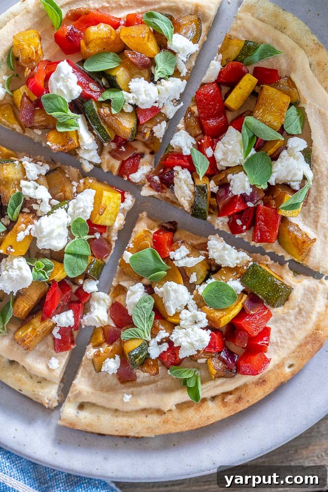 Effortless Vegetarian Meals for Week Two 6 Hummus flatbread topped with colorful roasted vegetables.