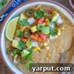 A bowl of creamy vegetarian white bean chili with fresh toppings