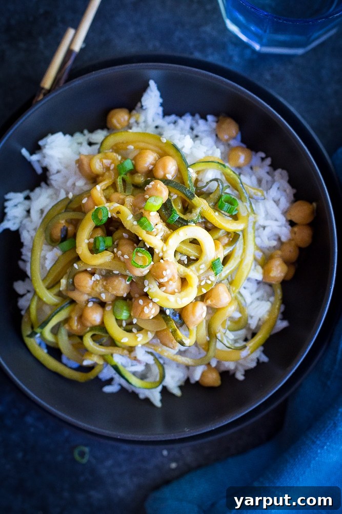 Simplify Your Week 5 Meals 5 A colorful bowl of orange ginger zucchini noodles tossed with chickpeas and fresh herbs, ready to be enjoyed.