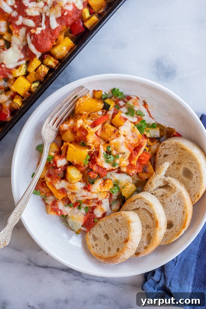 Oven-Roasted Polenta Garden Medley 5 Sheet Pan Polenta Vegetable Bake in a bowl with a fork
