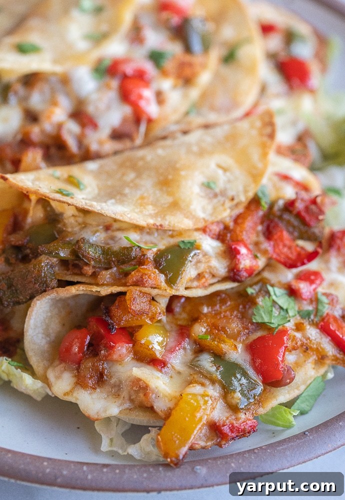 Crunchy Oven-Baked Fajita Tacos 5 close up of cheesy baked fajita tacos