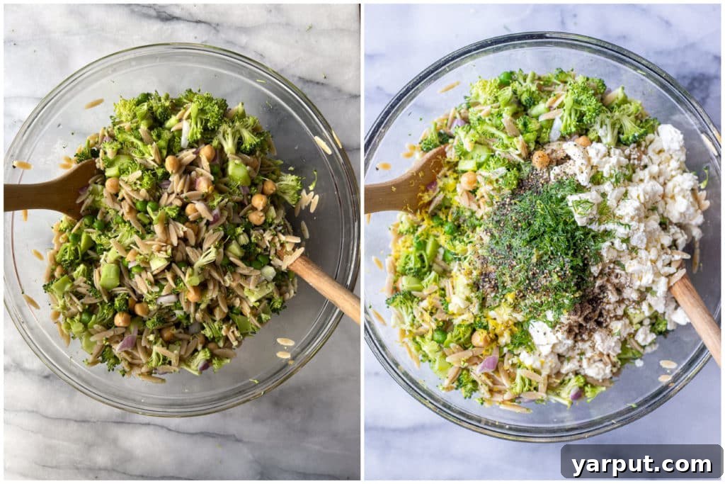 Bright Lemon Dill Orzo Broccoli Salad 4 A large serving bowl filled with mixed Lemon Dill Orzo Broccoli Salad, featuring prominent chickpeas and feta cheese.