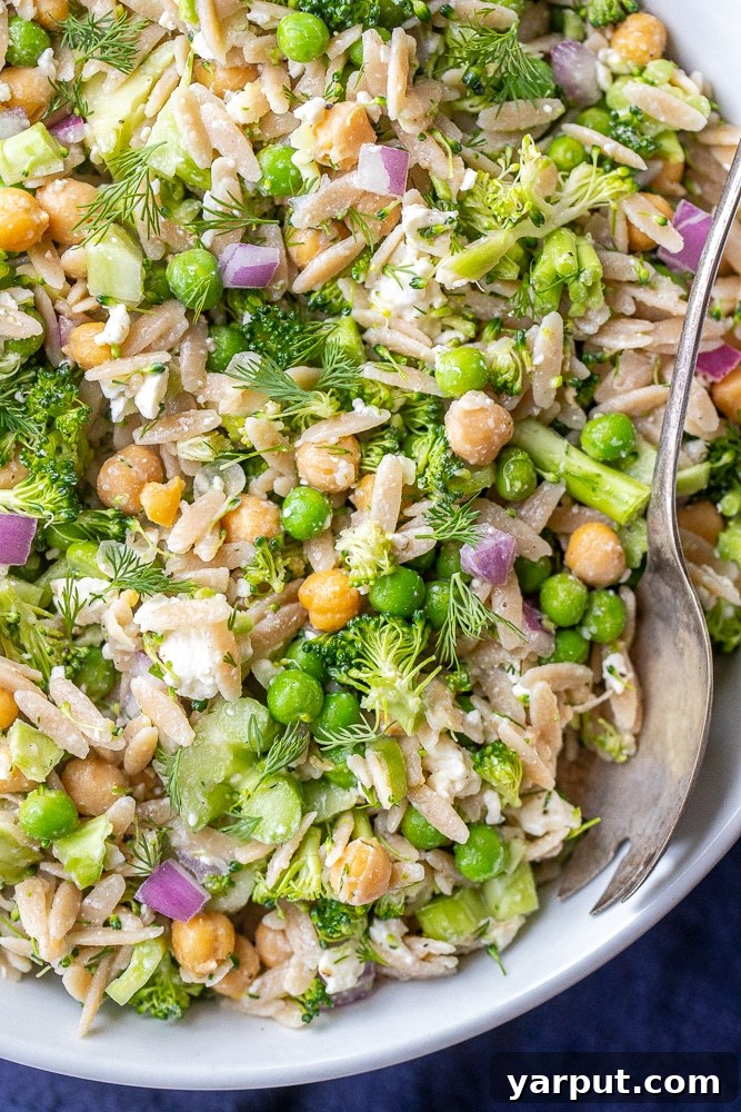 Bright Lemon Dill Orzo Broccoli Salad 6 Close-up of a single serving of Lemon Dill Orzo Broccoli Salad in a bowl, showing the vibrant colors and textures.