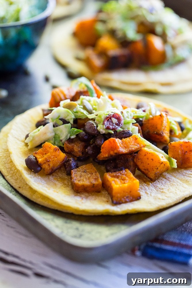 Unleash the Flavor: 21 Irresistible Veggie Tacos 18 Roasted Butternut Squash and Black Bean Tacos with crumbled cheese