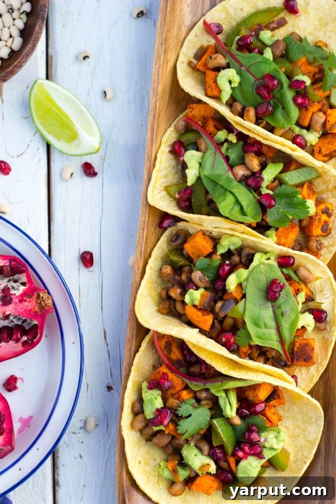 Unleash the Flavor: 21 Irresistible Veggie Tacos 23 Roasted Sweet Potato and Black Eyed Pea Tacos garnished with pomegranate seeds