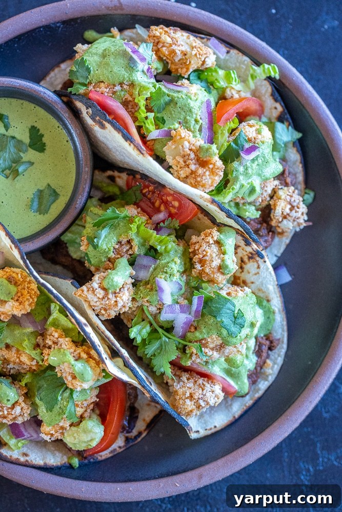 Unleash the Flavor: 21 Irresistible Veggie Tacos 6 Crispy Cauliflower Tacos drizzled with green tahini sauce