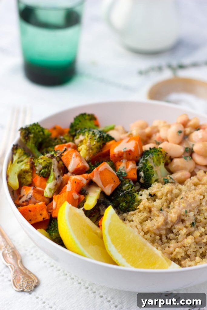 Ninth Week's Easy Veggie Delights 6 A vibrant bowl filled with roasted sweet potatoes, tender broccoli florets, white beans, and quinoa, topped with fresh avocado slices.