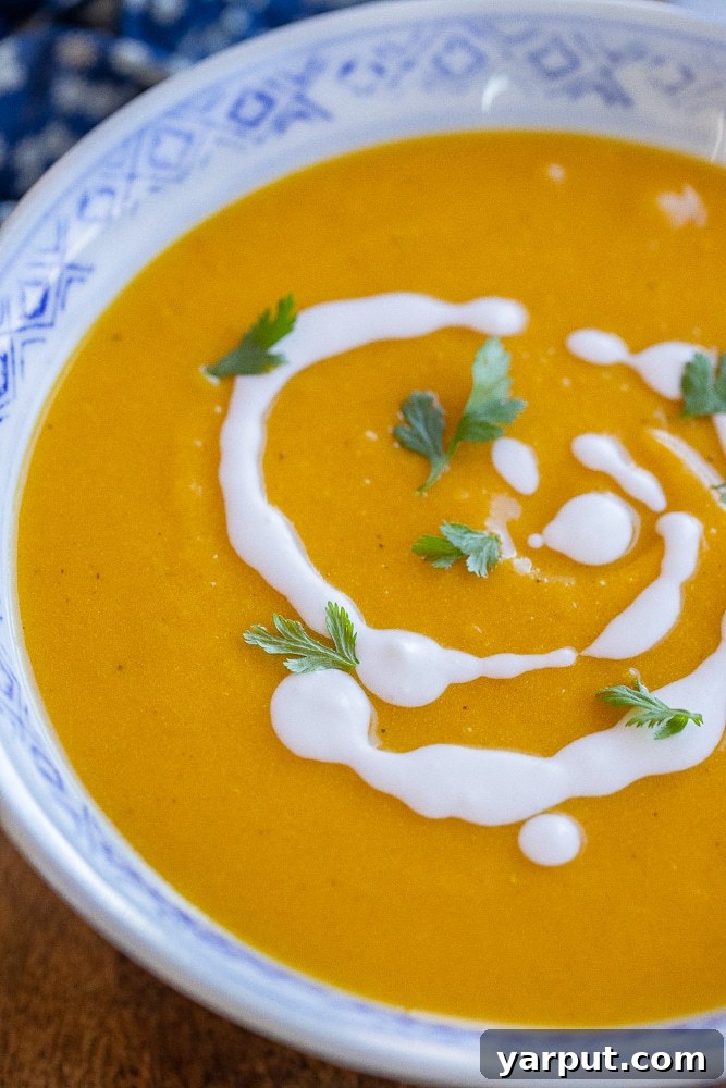 Golden Roasted Butternut Coconut Curry Soup 6 A close-up shot of a large bowl of curry roasted butternut squash soup, showing steam rising and inviting warmth.