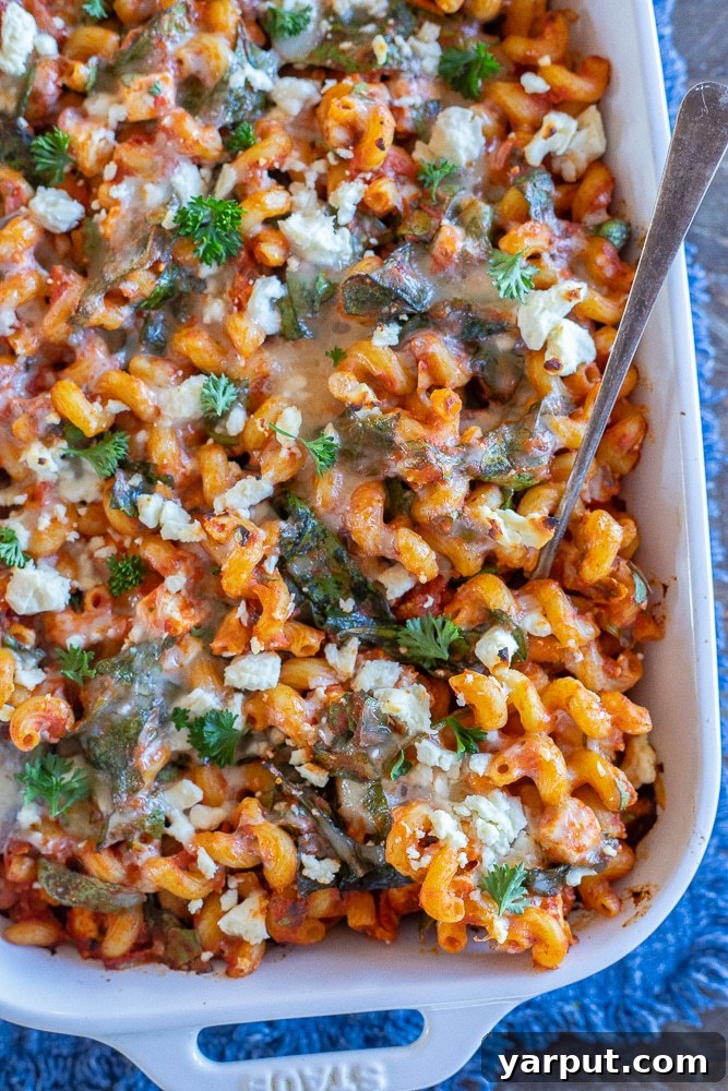 Frugal Feasts: Week 11 Meal Plan 4 A bubbling casserole dish of spinach feta baked pasta, ready to be served.