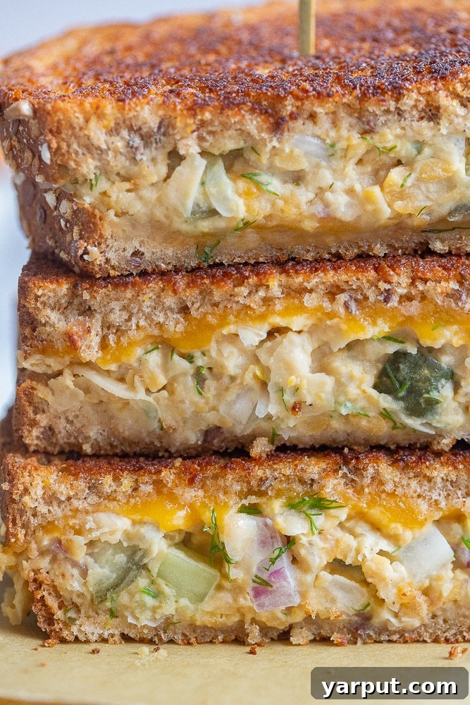 Frugal Feasts: Week 11 Meal Plan 5 Golden-brown chickpea salad melts on toasted bread, served with a side of chips.