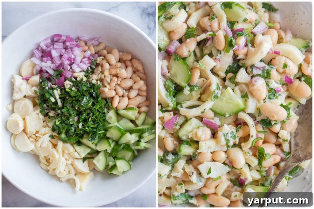 Lemony Hearts of Palm and White Bean Salad being mixed in a large bowl with all ingredients combined