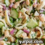A small bowl of Lemony Hearts of Palm and White Bean Salad ready for serving.