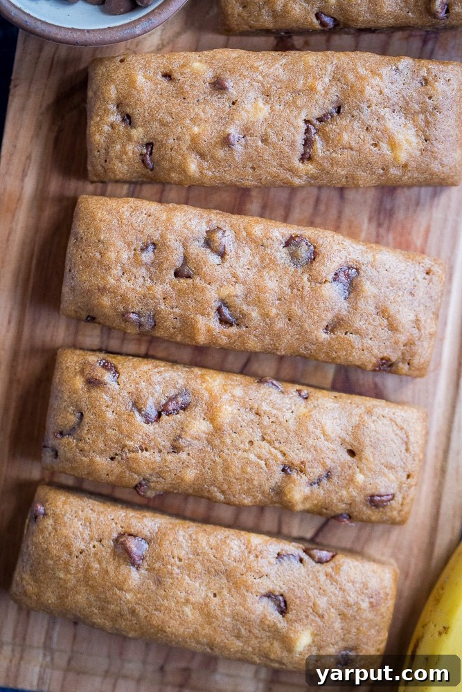 Ultimate Chocolate Chip Banana Bread Bars 5 A stunning shot of freshly baked Chocolate Chip Banana Bread Snacking Bars, perfectly golden and inviting, on a cutting board.