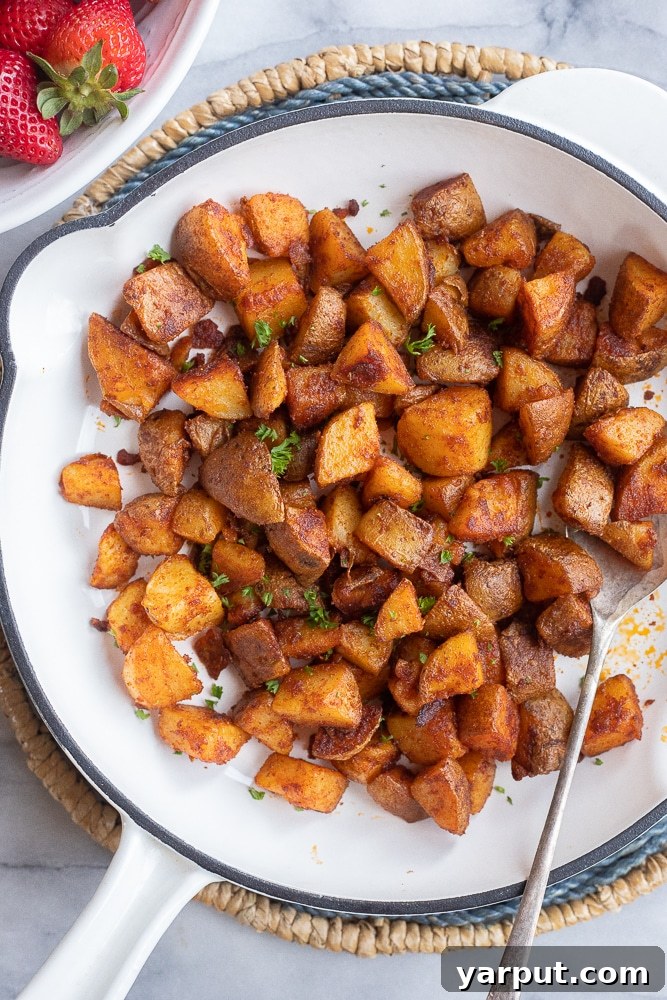 Easy Home Fries recipe in a skillet, garnished with fresh herbs and ready to serve