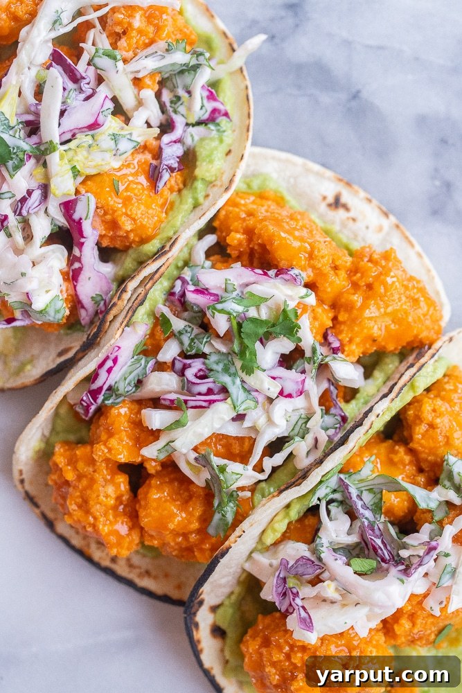 Bold Buffalo Crispy Tofu Tacos 5 Crispy Buffalo Tofu Tacos served beautifully with a side of creamy ranch slaw