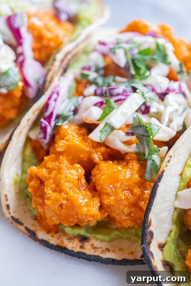 Bold Buffalo Crispy Tofu Tacos 6 Close-up of a crispy buffalo tofu bite nestled perfectly within a taco shell