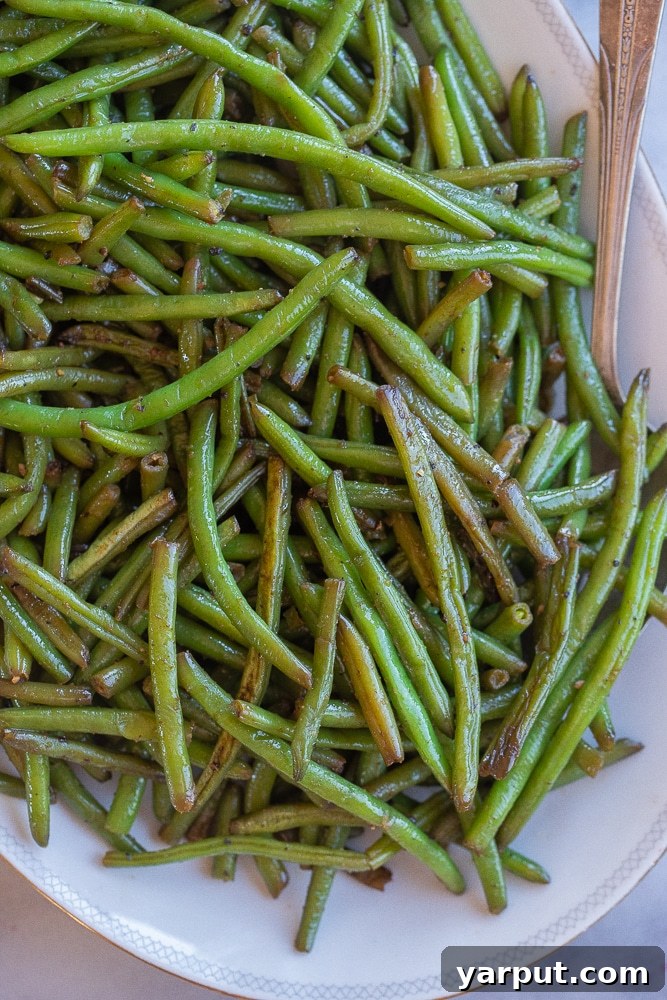 Effortless Green Bean Perfection 5 green bean side dish on a platter with a serving spoon